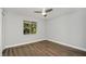 Simple bedroom with wood-look floors and a ceiling fan at 8607 Tarragon Dr, Orlando, FL 32825