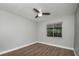 Bright bedroom featuring wood-look floors and ceiling fan at 8607 Tarragon Dr, Orlando, FL 32825