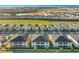 Aerial view of a community with many houses and a golf course at 8879 Cabot Cliffs Dr # 103, Davenport, FL 33896