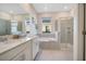 Elegant bathroom with double vanity, soaking tub, and walk-in shower at 8879 Cabot Cliffs Dr # 103, Davenport, FL 33896