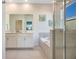 Elegant bathroom with double vanity and soaking tub at 8879 Cabot Cliffs Dr # 103, Davenport, FL 33896
