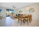 Bright dining area with wood table and chairs, adjacent to living room at 8879 Cabot Cliffs Dr # 103, Davenport, FL 33896