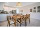 Bright dining area with wood table and chairs, adjacent to kitchen at 8879 Cabot Cliffs Dr # 103, Davenport, FL 33896