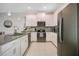 Modern kitchen with white cabinets, dark appliances, and an island at 8879 Cabot Cliffs Dr # 103, Davenport, FL 33896