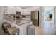 Modern kitchen with white cabinets, an island, and breakfast bar at 8879 Cabot Cliffs Dr # 103, Davenport, FL 33896