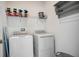 Bright laundry room with washer, dryer, and shelving at 8879 Cabot Cliffs Dr # 103, Davenport, FL 33896