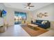 Spacious living room featuring a comfy sofa and sliding doors to balcony at 8879 Cabot Cliffs Dr # 103, Davenport, FL 33896