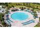 Circular pool with surrounding lounge chairs and patio area at 8879 Cabot Cliffs Dr # 103, Davenport, FL 33896