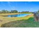Serene backyard featuring a pond and green lawn at 1062 Umbria Dr, Kissimmee, FL 34759