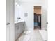 Bathroom with gray double vanity, walk-in closet, and tile floor at 1062 Umbria Dr, Kissimmee, FL 34759