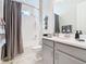 Bathroom with tub, shower, gray vanity, and gray walls at 1062 Umbria Dr, Kissimmee, FL 34759