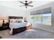 Bedroom with lake view, ceiling fan and ensuite bath at 1062 Umbria Dr, Kissimmee, FL 34759
