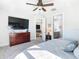 Main bedroom with large TV, dresser, and ensuite bath at 1062 Umbria Dr, Kissimmee, FL 34759