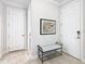 Bright and airy entryway with bench and art at 1062 Umbria Dr, Kissimmee, FL 34759