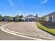 Two-car garage, light gray exterior, and a paved driveway at 1062 Umbria Dr, Kissimmee, FL 34759