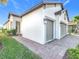 Two-car garage, light gray exterior, and a paved walkway at 1062 Umbria Dr, Kissimmee, FL 34759