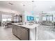 Open concept kitchen with island and dining area at 1062 Umbria Dr, Kissimmee, FL 34759