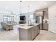 Open kitchen with island, stainless appliances, and breakfast bar at 1062 Umbria Dr, Kissimmee, FL 34759