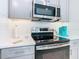 Modern kitchen features stainless steel appliances and white cabinets at 1062 Umbria Dr, Kissimmee, FL 34759