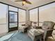 Bright sunroom featuring wicker chairs and a ceiling fan at 1062 Umbria Dr, Kissimmee, FL 34759