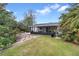 Large backyard with screened patio and grassy area at 110 Talavera Ln, Kissimmee, FL 34758