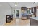 Modern kitchen with stainless steel appliances and granite countertops, open to dining area at 110 Talavera Ln, Kissimmee, FL 34758