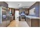 Modern kitchen with stainless steel appliances and granite countertops at 110 Talavera Ln, Kissimmee, FL 34758