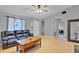 Living room with black leather couch, coffee table, and ceiling fan at 110 Talavera Ln, Kissimmee, FL 34758