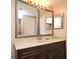 Bathroom boasts double vanity, large mirrors, and updated cabinetry at 12414 Baleria Cv # 108, Orlando, FL 32837