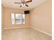 Bright bedroom with tile flooring, ceiling fan, and large windows at 12414 Baleria Cv # 108, Orlando, FL 32837