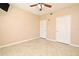 Large bedroom with tile floors, ceiling fan and double entry doors at 12414 Baleria Cv # 108, Orlando, FL 32837
