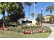 Community entrance sign with landscaping and palm trees at 12414 Baleria Cv # 108, Orlando, FL 32837