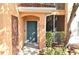Condo entrance with teal door, showcasing a well-maintained building exterior at 12414 Baleria Cv # 108, Orlando, FL 32837