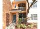 Inviting condo exterior featuring a teal door and screened balcony at 12414 Baleria Cv # 108, Orlando, FL 32837