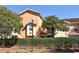 Two-story building with balconies and neatly manicured hedges at 12414 Baleria Cv # 108, Orlando, FL 32837