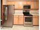 Stainless steel appliances and light wood cabinets in this updated kitchen at 12414 Baleria Cv # 108, Orlando, FL 32837