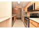 Modern kitchen with stainless steel appliances and light wood cabinets at 12414 Baleria Cv # 108, Orlando, FL 32837