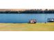 Serene backyard setting with a private dock and picturesque lake views at 1296 Skyline Dr, Tavares, FL 32778