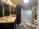 Clean bathroom with bathtub, toilet, and dark vanity at 1296 Skyline Dr, Tavares, FL 32778