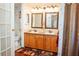 Double vanity bathroom with wood cabinets and flooring at 1296 Skyline Dr, Tavares, FL 32778