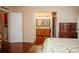 Bedroom with access to bathroom and hardwood floors at 1296 Skyline Dr, Tavares, FL 32778