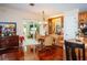 Kitchen dining area with hardwood floors and view into living room at 1296 Skyline Dr, Tavares, FL 32778