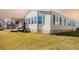 Single-wide manufactured home with deck and stone siding at 1296 Skyline Dr, Tavares, FL 32778