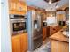 Kitchen with stainless steel appliances and wood cabinets at 1296 Skyline Dr, Tavares, FL 32778