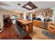 Open concept kitchen with island and hardwood floors at 1296 Skyline Dr, Tavares, FL 32778