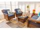 Bright sunroom with wicker furniture and lake view at 1296 Skyline Dr, Tavares, FL 32778