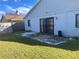 House backyard with patio and grassy area at 136 Pinewood Cir, Kissimmee, FL 34743
