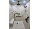 Large walk-in shower with marble tile, dual shower heads, built-in seat, and grab bars at 136 Pinewood Cir, Kissimmee, FL 34743