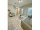 Living room with tile floors, gray couch, and entryway view at 1478 Garden Arbor Ln, Orlando, FL 32824