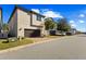 Townhouse exterior showcasing a garage and a paved driveway at 14791 Crimson Bluff Aly, Winter Garden, FL 34787